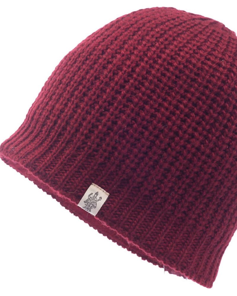 Front of a model wearing a size one-size-fits-all Cardigan Knit Beanie In Burgundy in Burgundy by Nirvanna Designs. | dia_product_style_image_id:350200